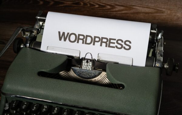 a close up of a typewriter with the word wordpress printed on it